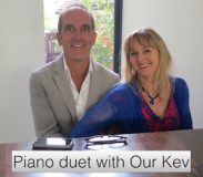 What does watching a reality show say about you? Photo of Kevin McCloud and Lysette Offley playing a piano duet